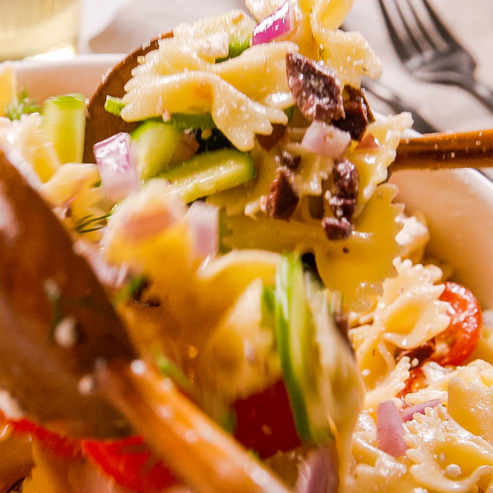 bowtie pasta tossed with tomatoes, cucumber, feta, red onion, and olives