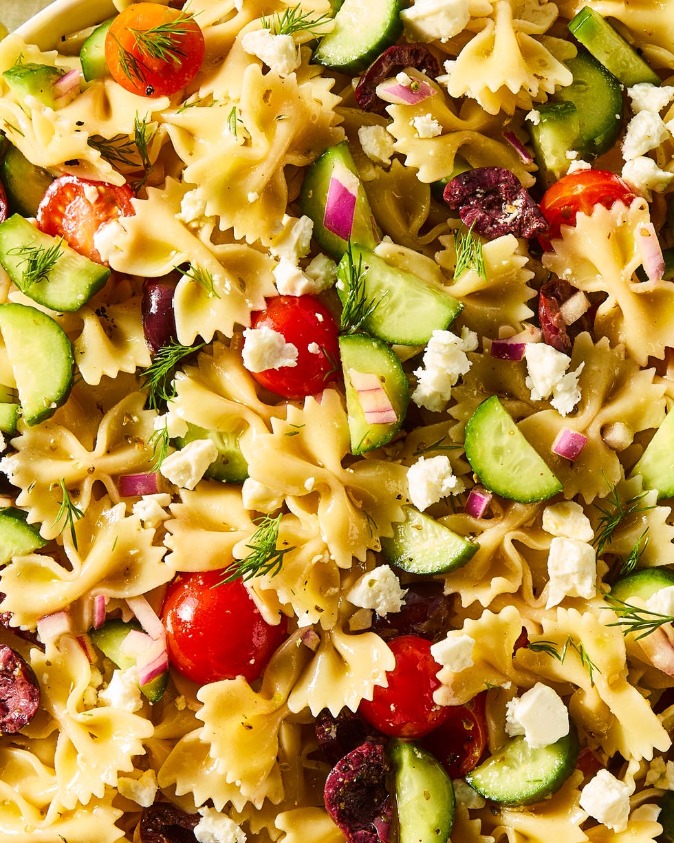 bowtie pasta tossed with cherry tomatoes, cucumbers, feta, and olives