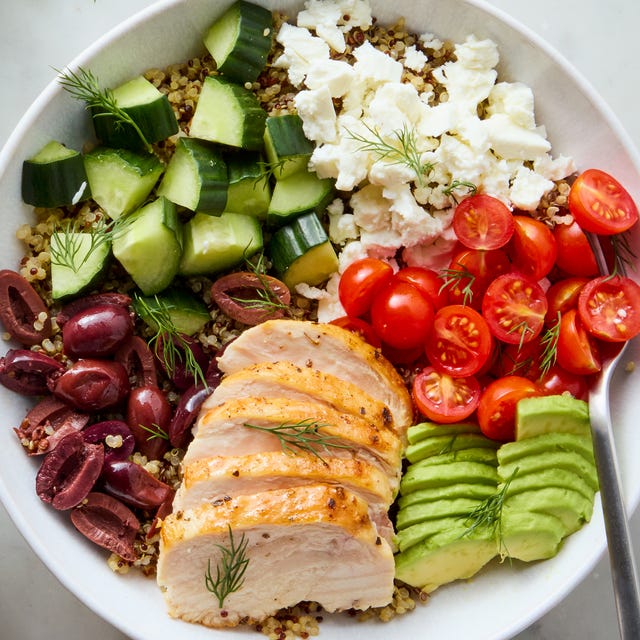 Greek Power Bowls bowls filled with chicken, tomatoes, cucumber, olives, feta, and avocado
