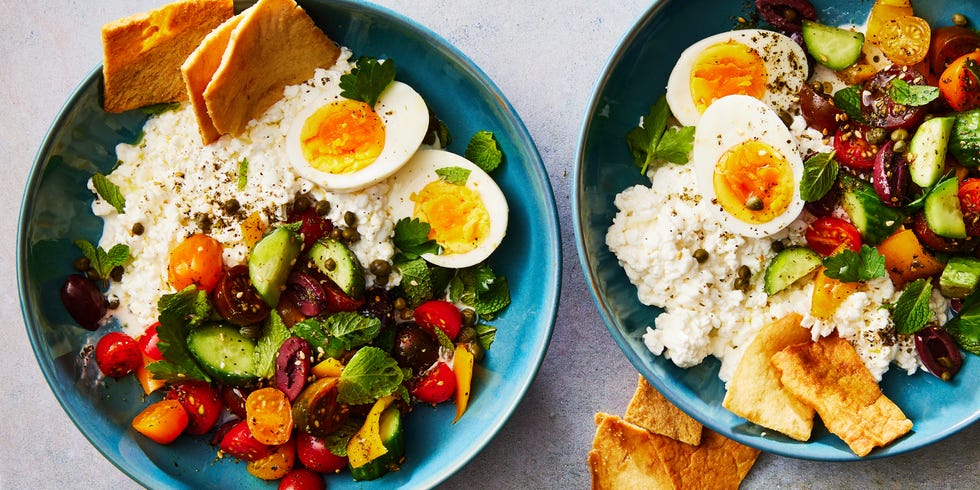 cottage cheese, soft boiled eggs, and a cucumber tomato salad topped with pita chips