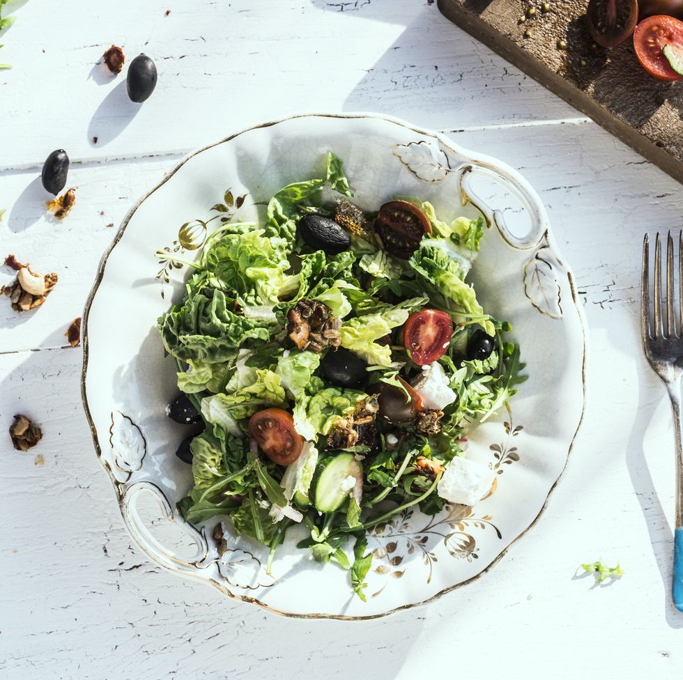 Greek salad with arugula, cheece, olives, tomatoes, cucumber, onion and caramelized nuts
