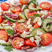 closeup of greek salad with cucumbers, tomato, kalamatas, red onion, and feta closeup of greek salad with cucumbers, tomato, kalamatas, red onion, and feta