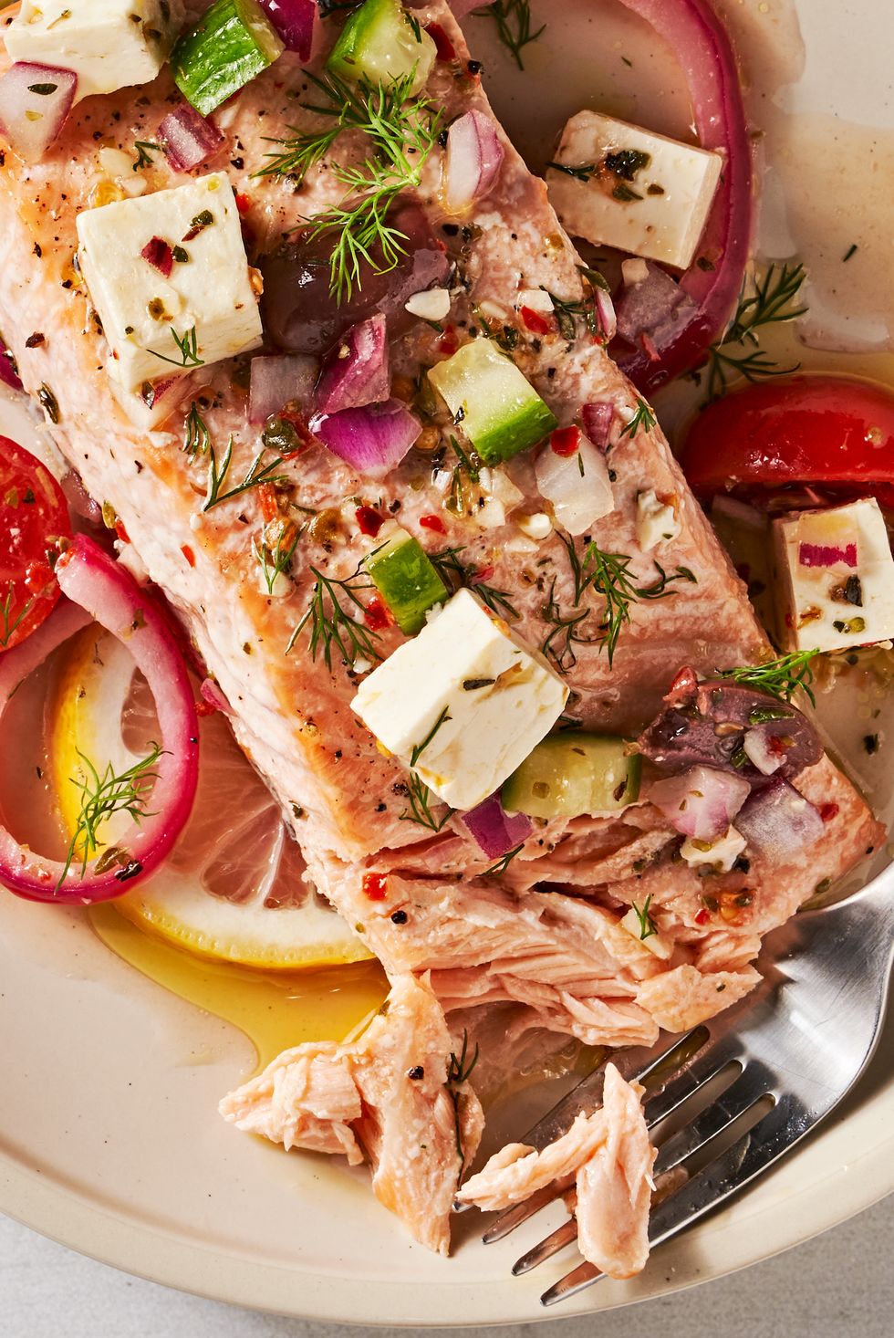greek salmon with feta, tomatoes, lives, red onion, and cucumber