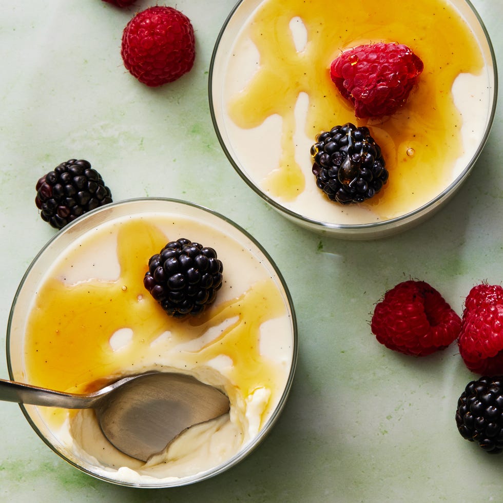 greek yogurt panna cotta topped with honey, raspberries, and blackberries
