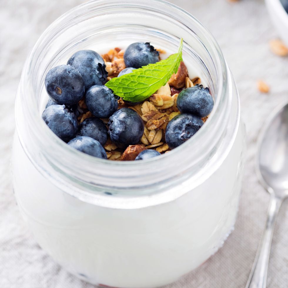 greek yogurt with blueberries and granola in a jar