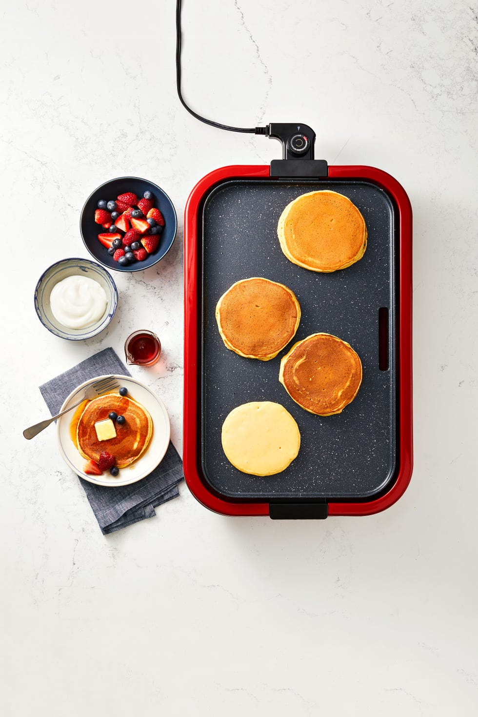 greek yogurt pancakes on a pancake griddle