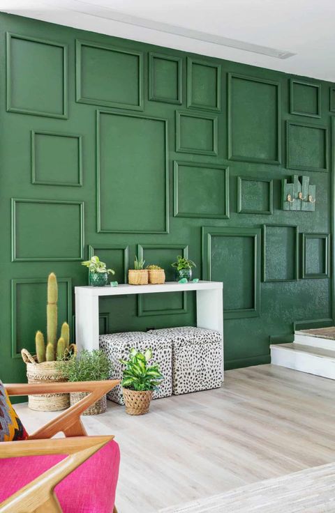 green accent wall with painted frames