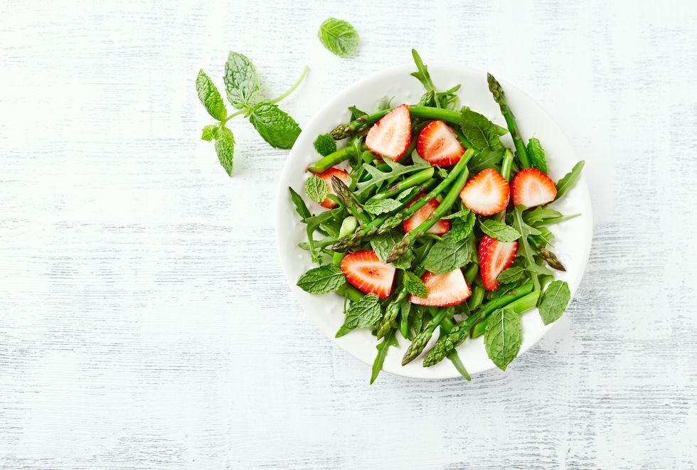 green asparagus and strawberry salad with arugula, mint and lemon honey dressing