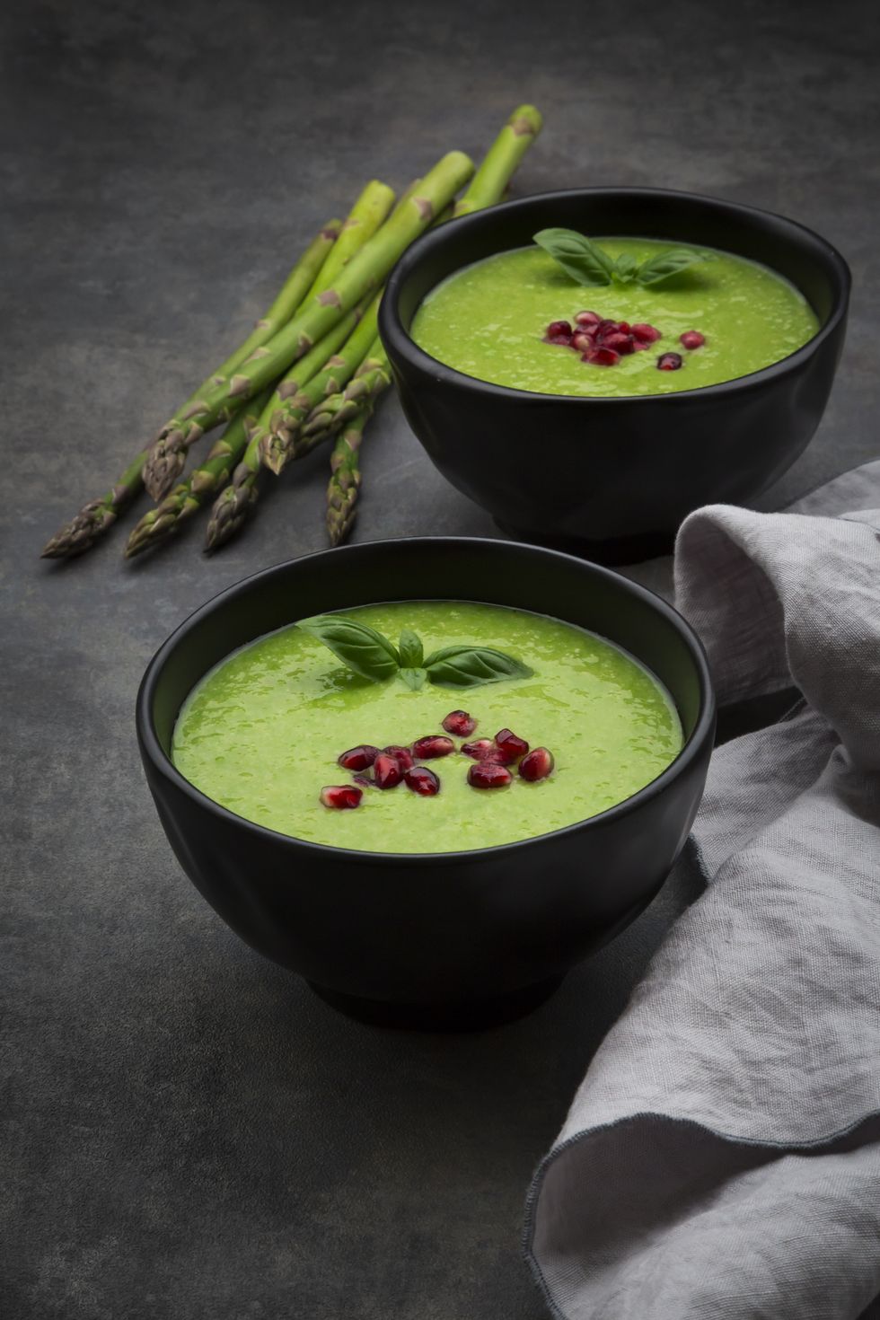 green asparagus soup with pomegranate seeds and basil