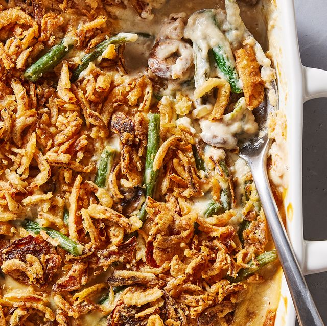 green bean casserole in a white baking dish with crunchy onions on top
