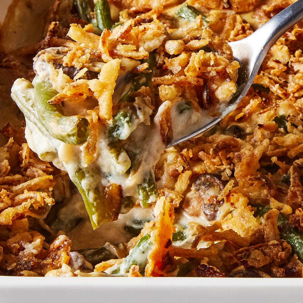 green bean casserole in a white baking dish with crunchy onions on top