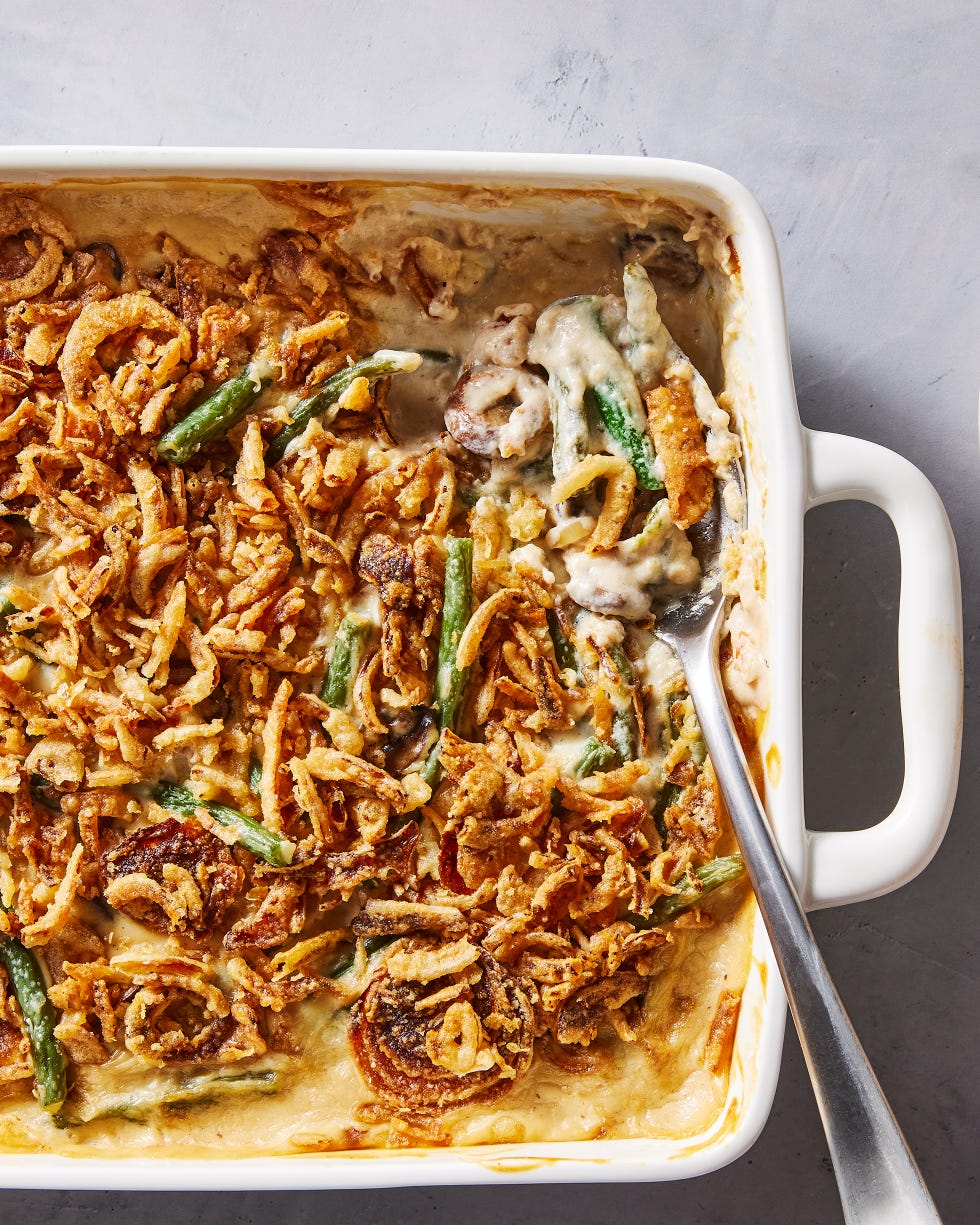 green bean casserole in a white baking dish with crunchy onions on top
