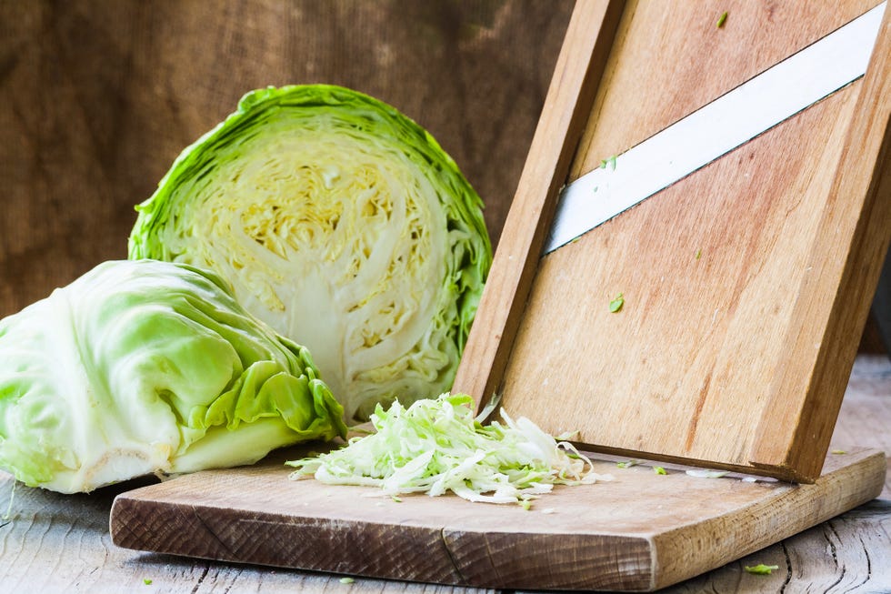 green cabbage shredded on cutting board