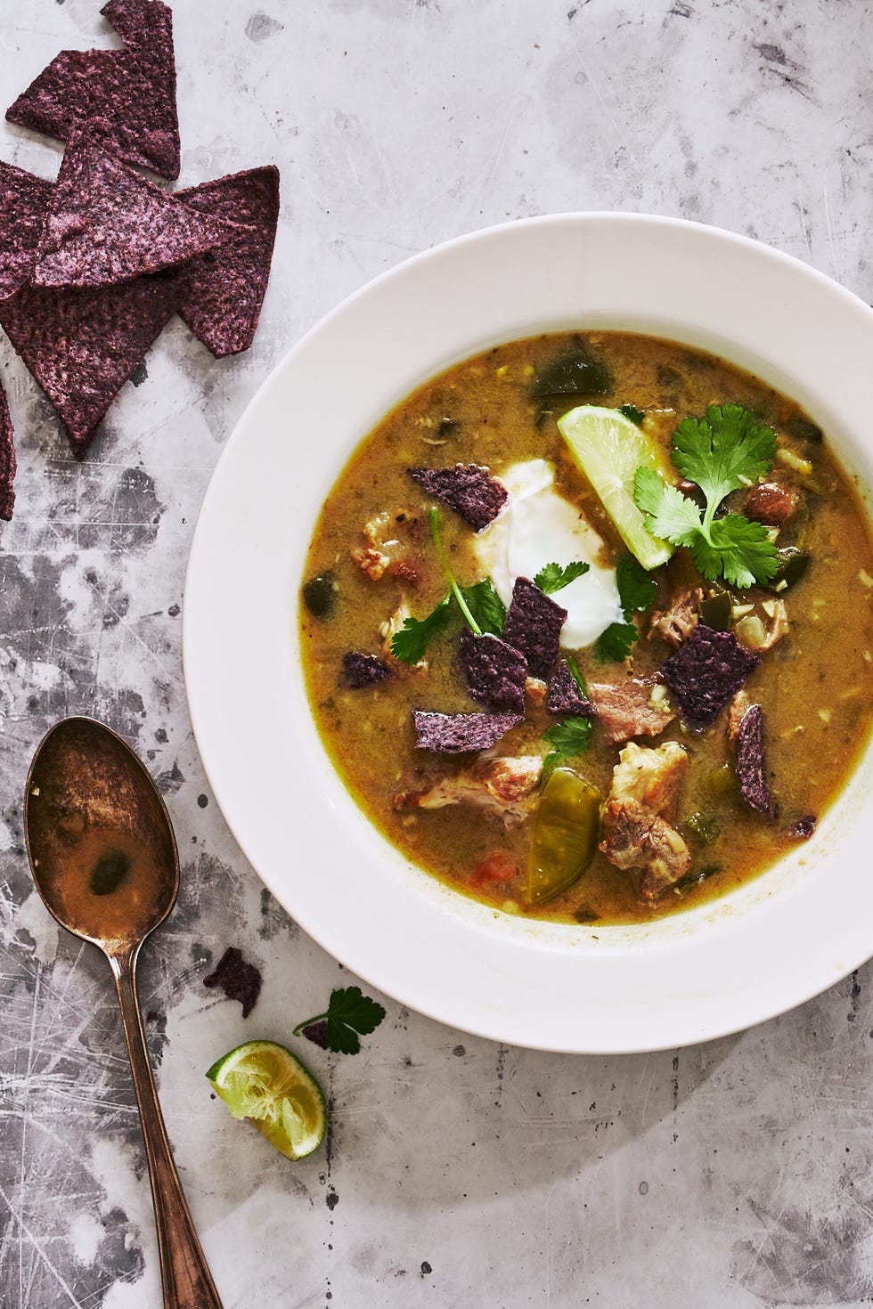 green chili pork stew topped with blue corn tortilla chips