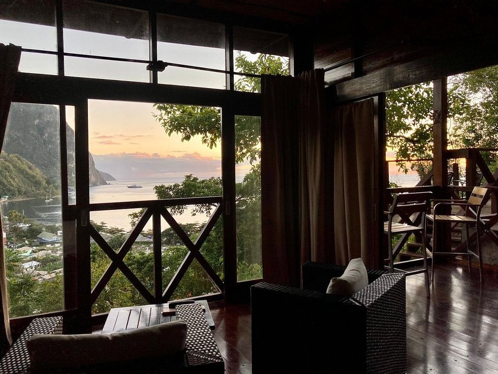 a room with a view of the water and mountains