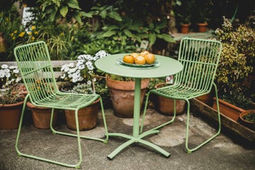green garden furniture in a small garden