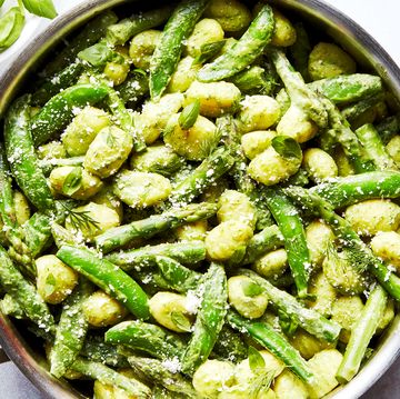 gnocchi tossed in a green sauce with asparagus