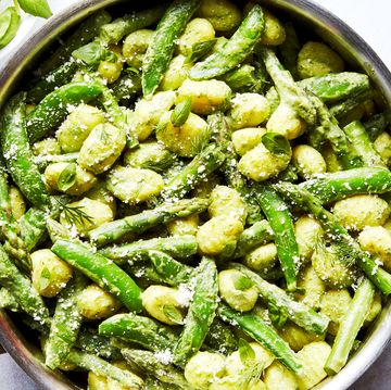 gnocchi tossed in a green sauce with asparagus