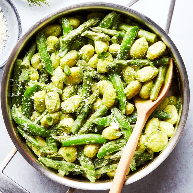 gnocchi tossed in a green sauce with asparagus