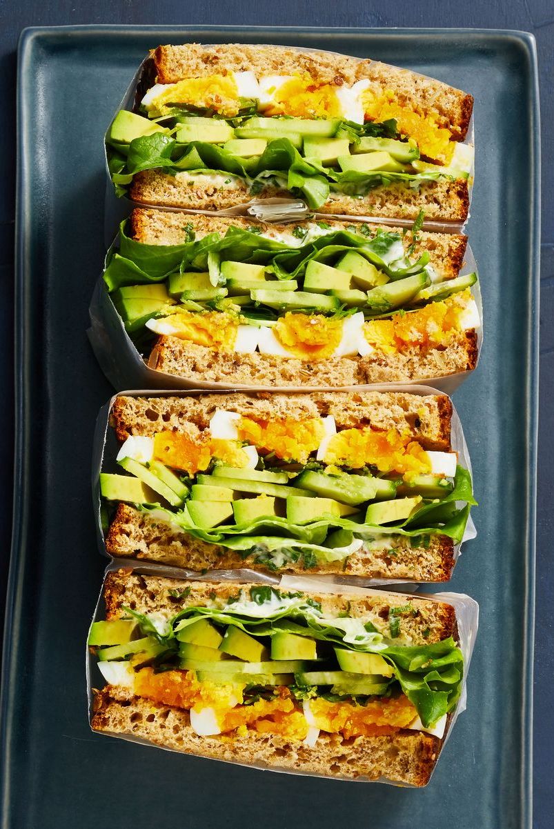 egg and avocado sandwiches stacked on top of each other