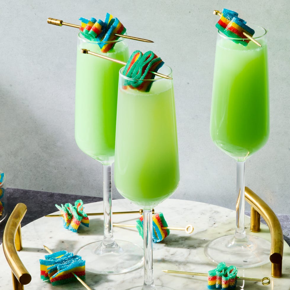 green mimosas with a sour candy garnish