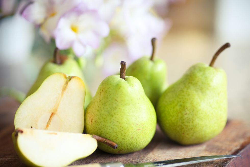 Green Pears on Wooden Board