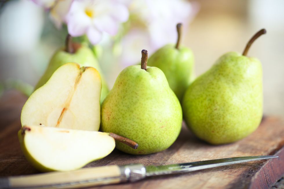 Green Pears on Wooden Board