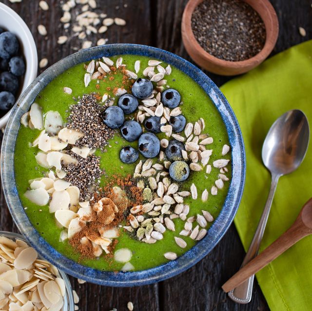 green smoothie bowl with almonds, blueberries, chia and sunflower seeds