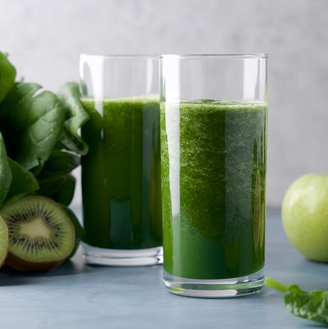 green smoothie in  glass spinach, apple, kiwi, lemon, lime ingredients