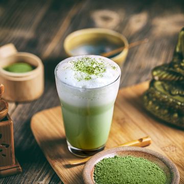 still life with japanese matcha accessories and matcha tea latte in glass