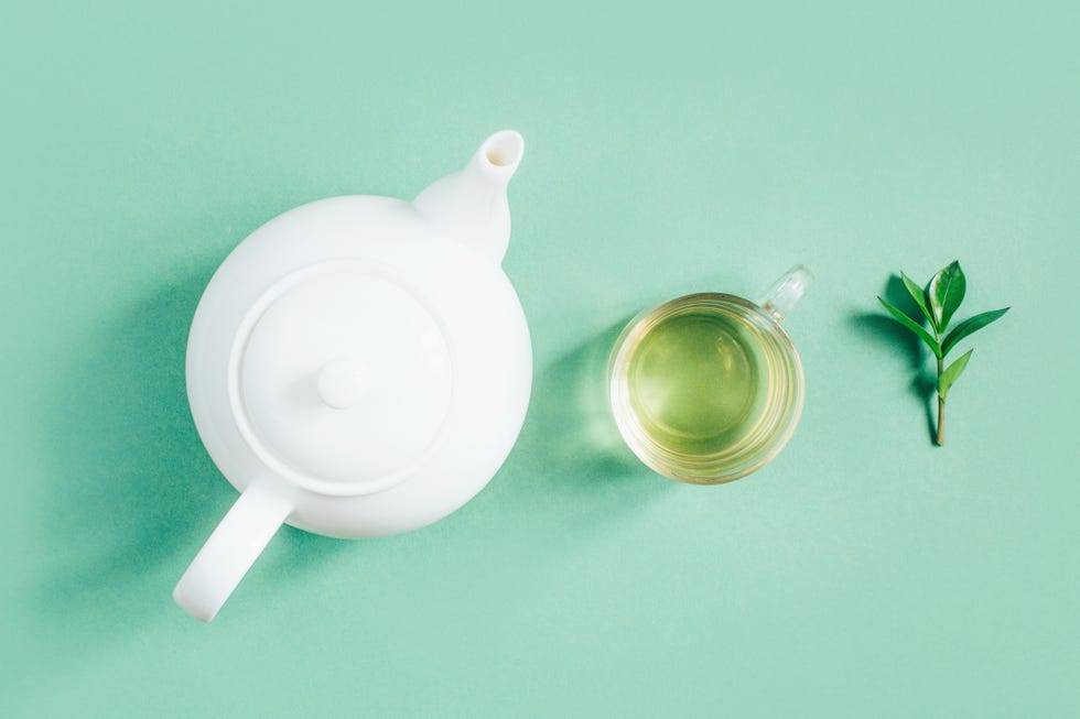 white tea kettle and cup of green tea