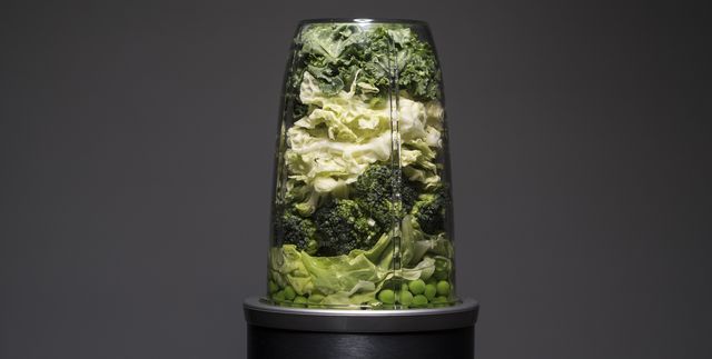 Green vegetables in a blender for smoothie drink