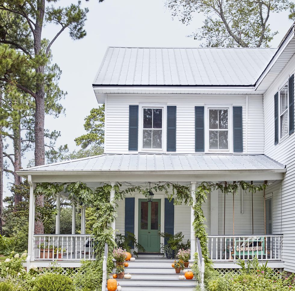 fall porch with pumpkins and green vines
