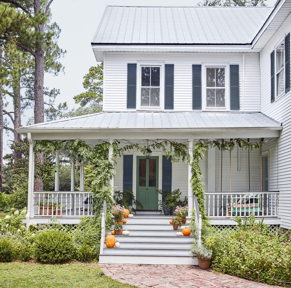 fall porch with pumpkins and green vines
