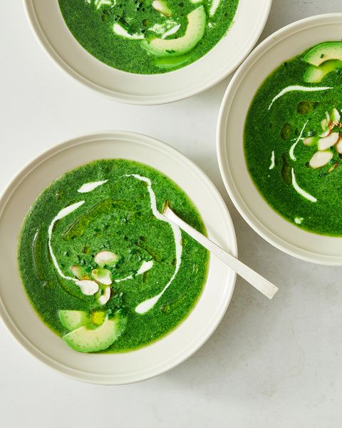 bowls of green goddess soup on a white background