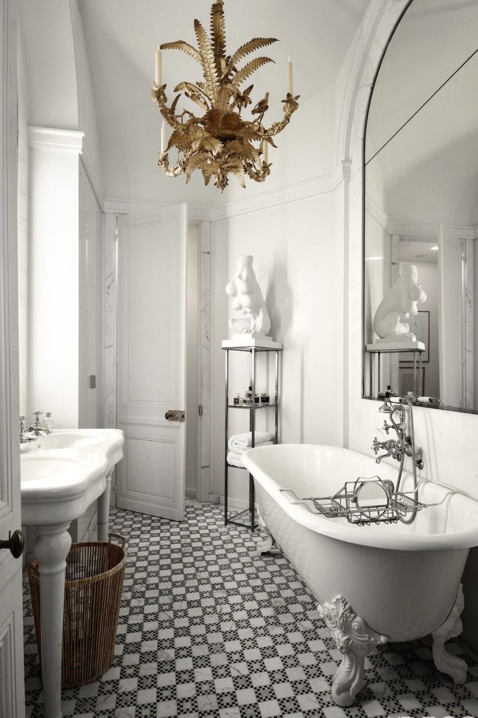 bathroom with ornate touches like a claw footed tub gold candelabra and checkerboard floor