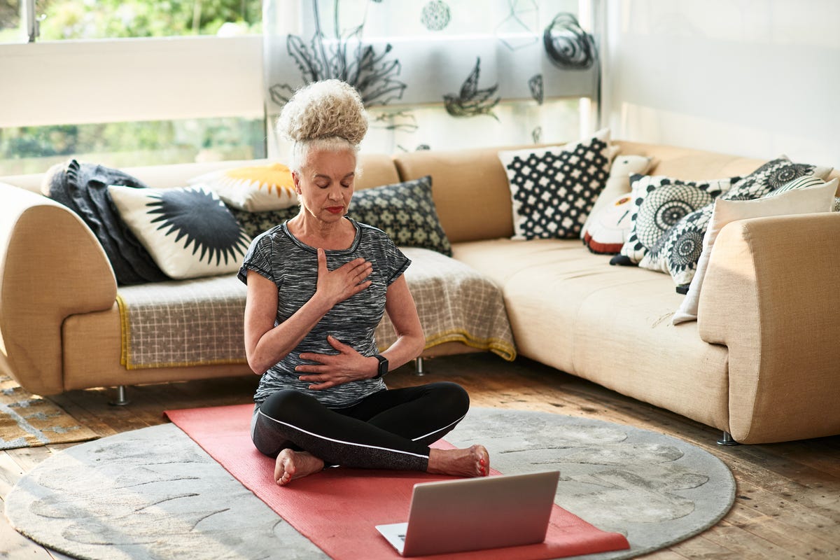 Premium Photo  Yoga lessons online positive yoga girl doing morning  practice in front of laptop at home