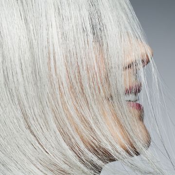 grey haired woman profile with hair covering face