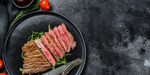 grilled and cut flat iron steak marble beef meat black background top view copy space