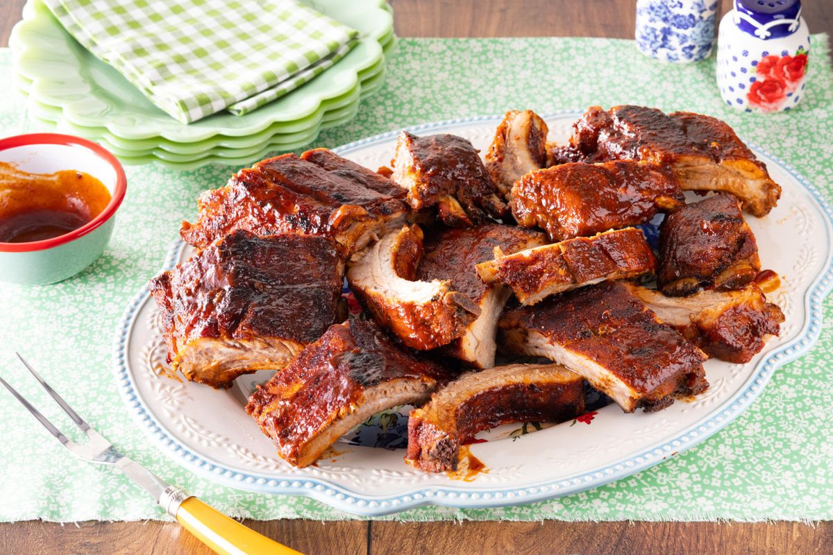 grilled bbq ribs on platter and green floral table linen