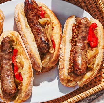 Grilled Beer Brats grilled bratwurst braised with beer in a pan with caramelized onions and bell peppers