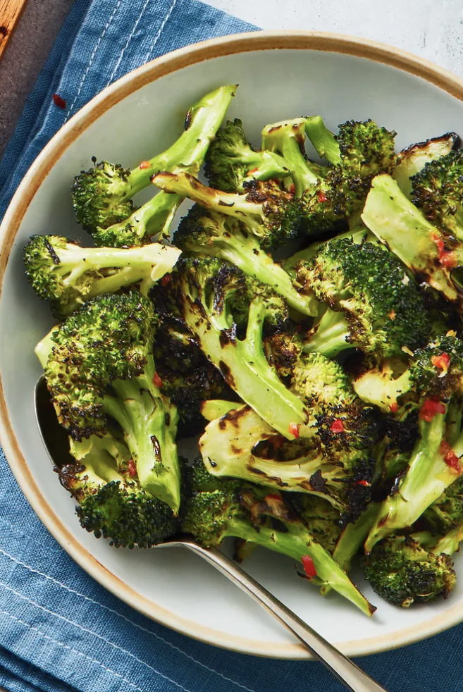 grilled broccoli with pepper flakes in a white bowl