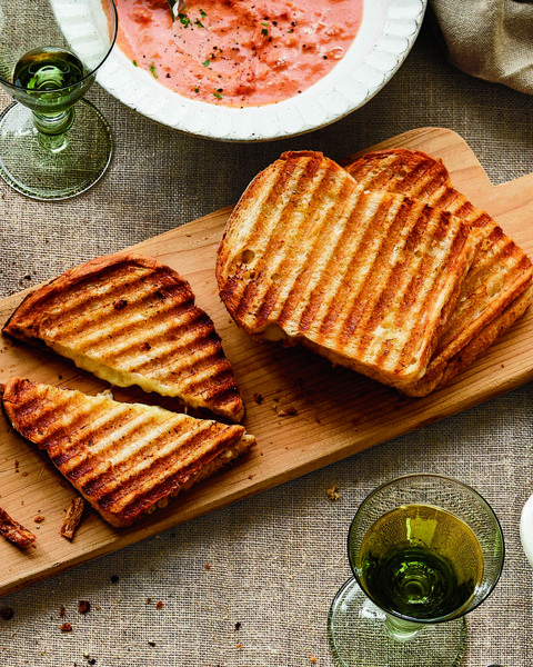 ina garten's cheddar and chutney grilled cheese sandwiches served on wood cutting board atop burlap table cloth