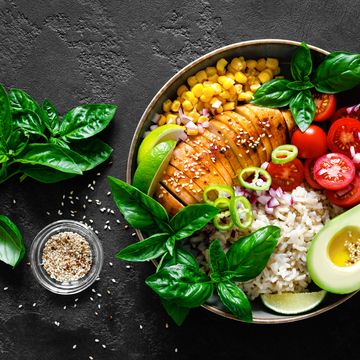 grilled chicken breast lunch bowl with fresh tomato, avocado, corn, red onion, rice and basil