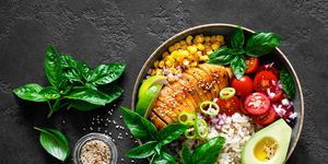 grilled chicken breast lunch bowl with fresh tomato, avocado, corn, red onion, rice and basil
