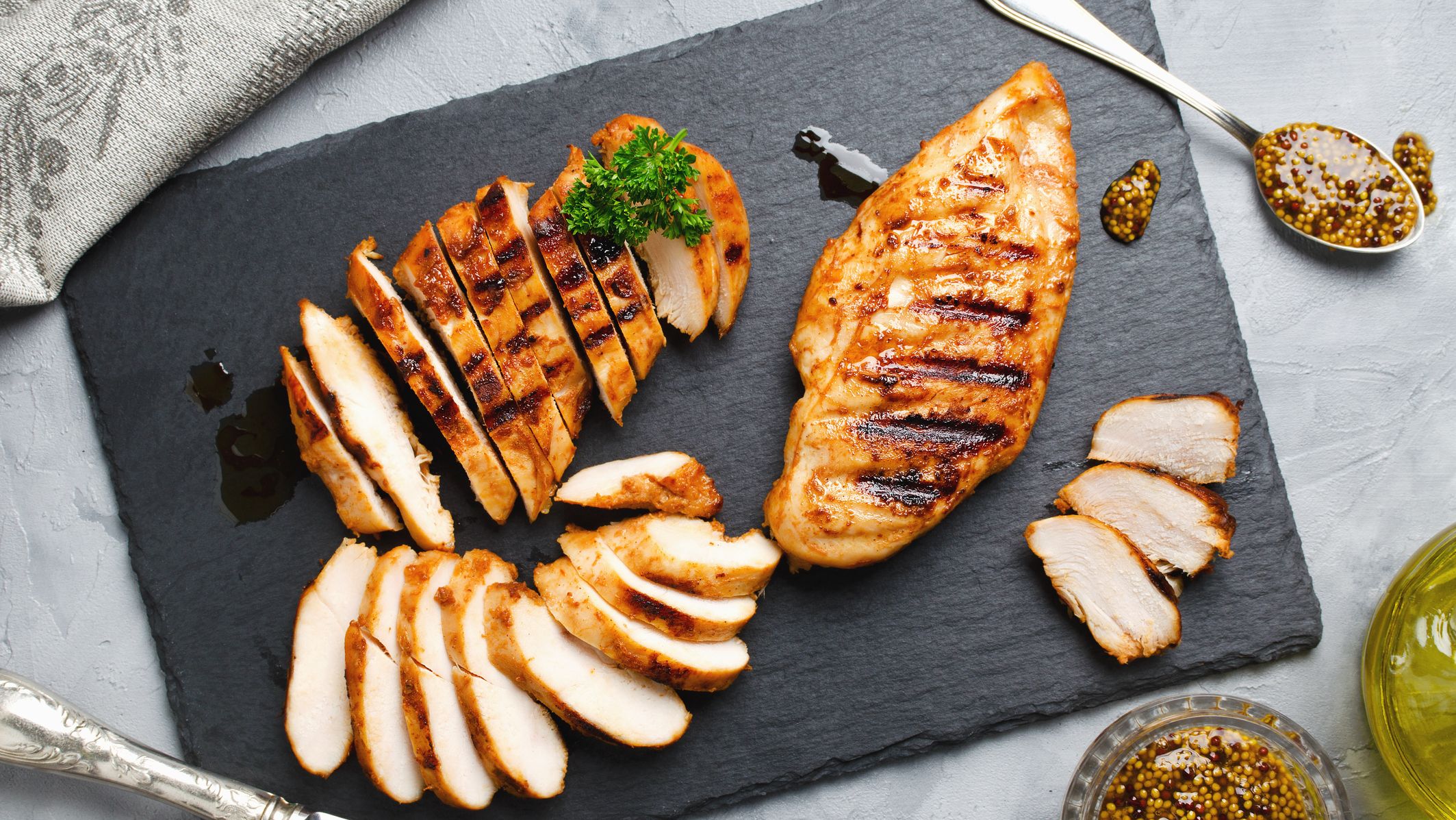 https://hips.hearstapps.com/hmg-prod/images/grilled-chicken-fillets-in-a-spicy-marinade-royalty-free-image-1633985003.jpg?crop=1xw:0.84953xh;center,top