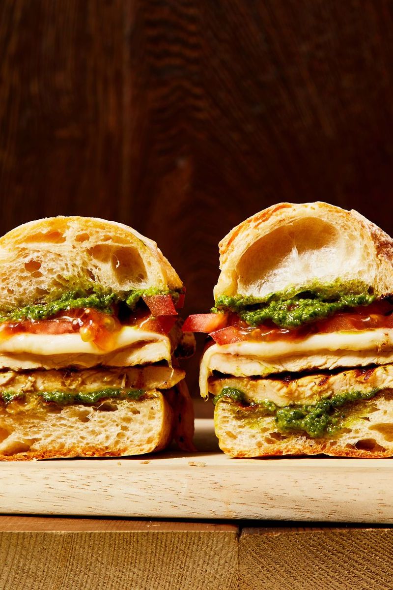 grilled chicken sandwiches on a wooden board