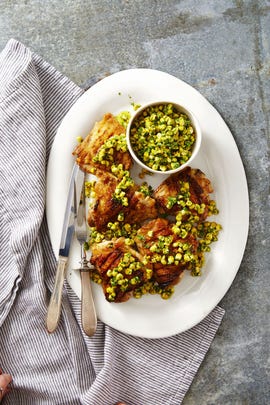 grilled chicken with herbed corn salsa on a white plate