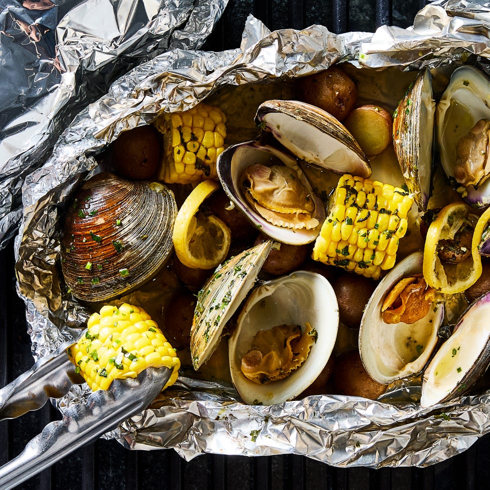 clams, corn, and potatoes in a grilled foil pack