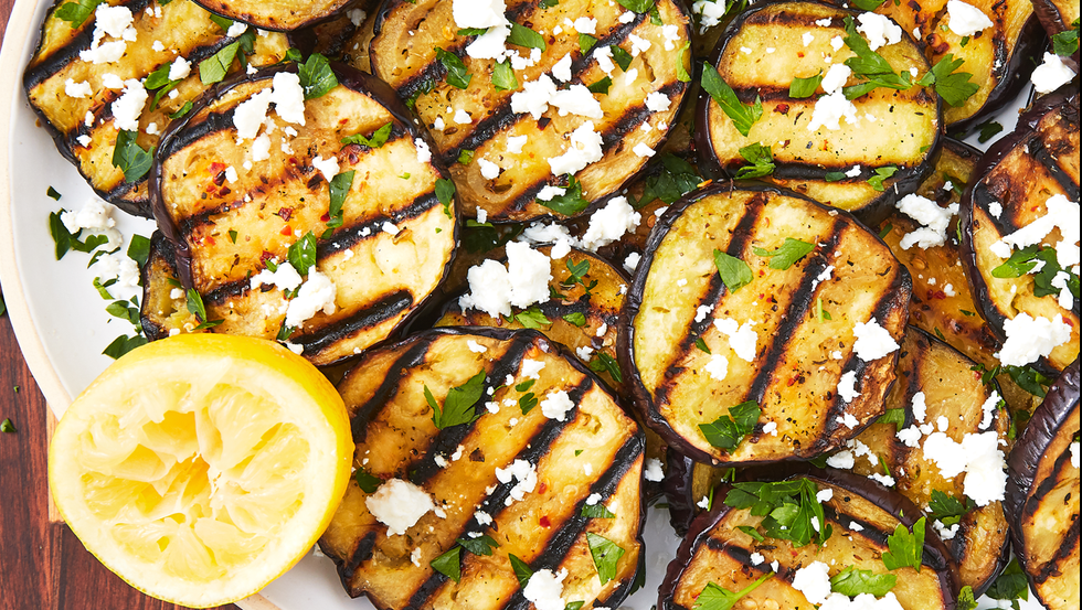 grilled eggplant rounds topped with chopped parsley and feta